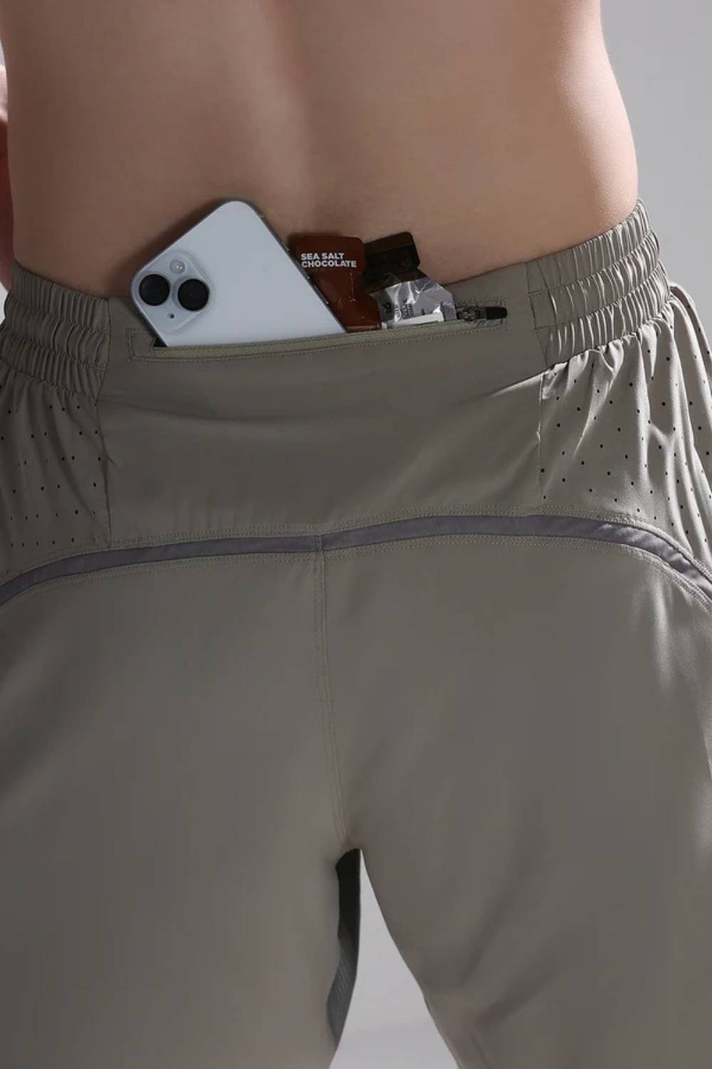 Zippered back pocket of men’s Pulse Cross Training Shorts securely holding phone #Color_Tech Beige